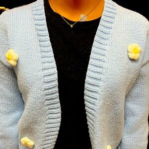 Blue cardigan with daisy on it